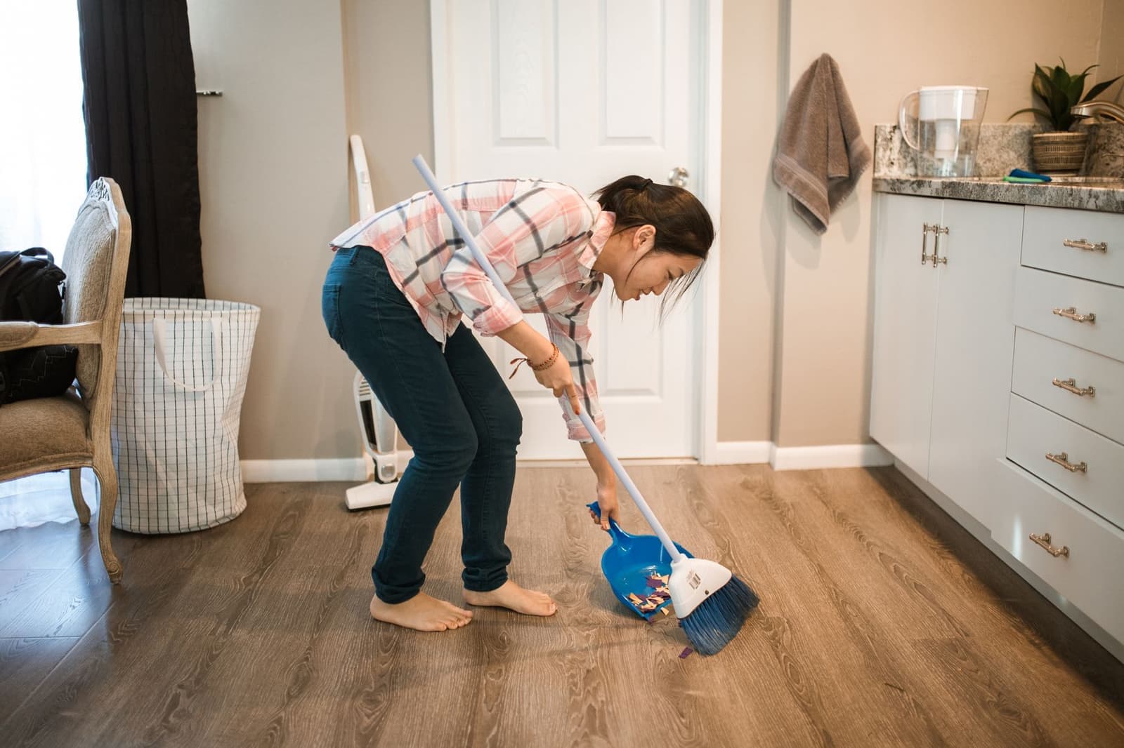 A person sweeping the floor at home