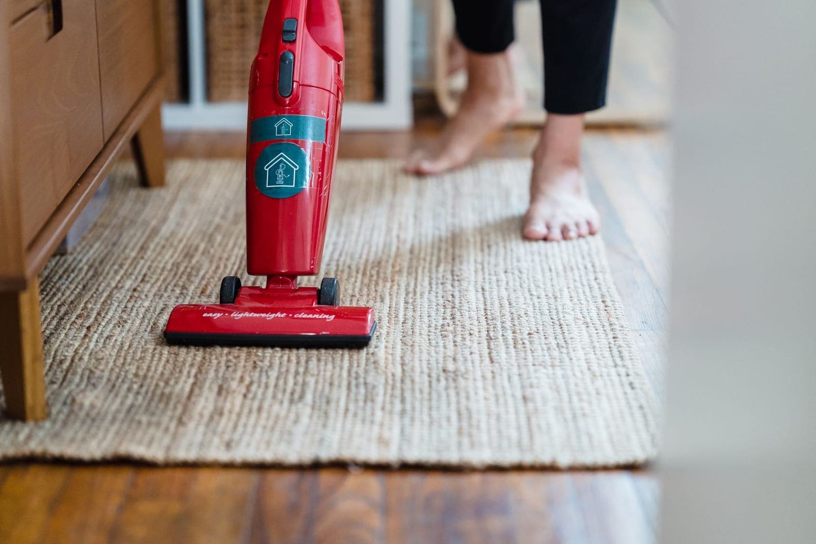 A vacuum cleaner being used on a carpet in a living room