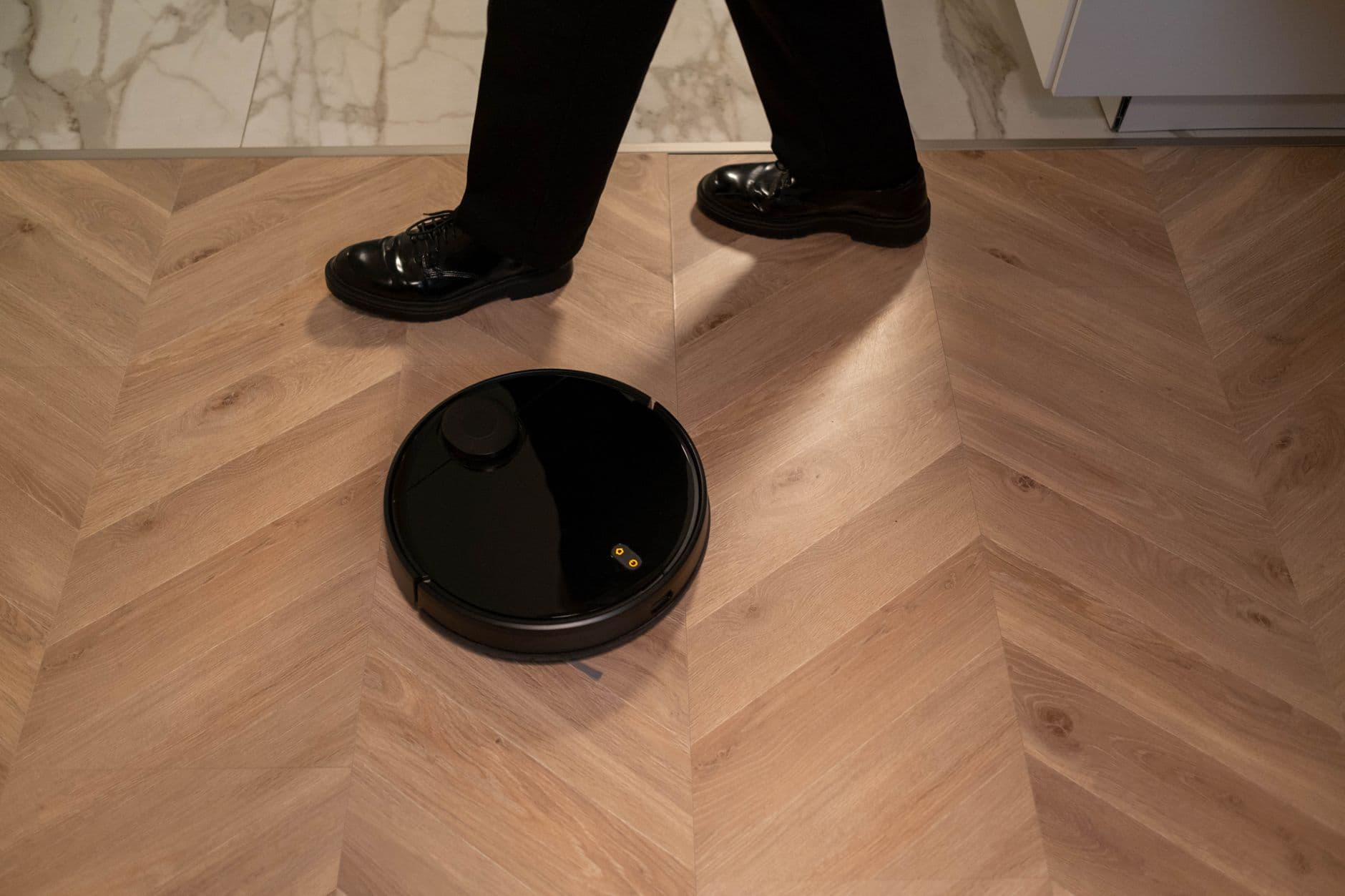 A robot vacuum cleaning a wooden floor