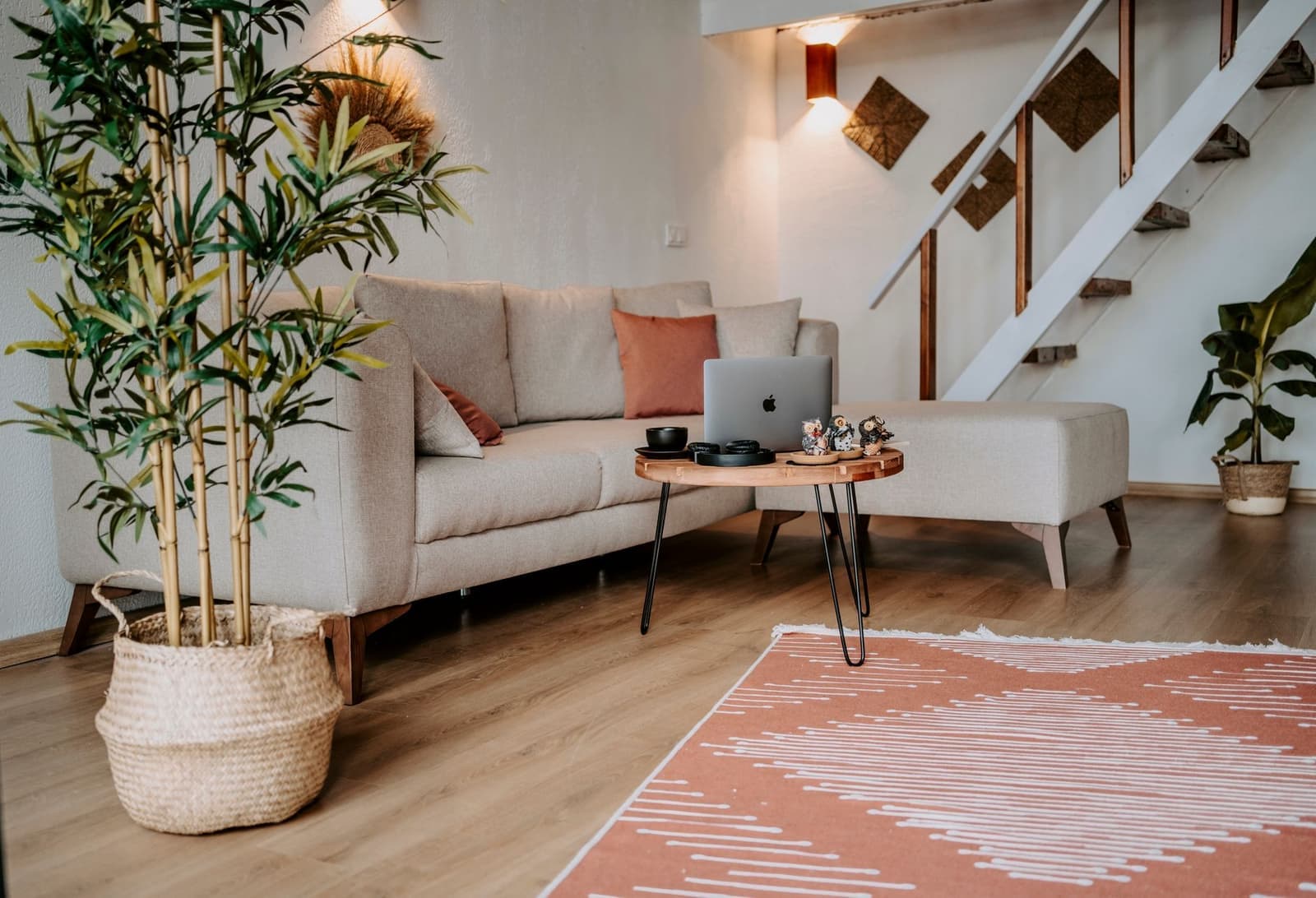 A living room with a sofa, a wooden coffee table and soft light