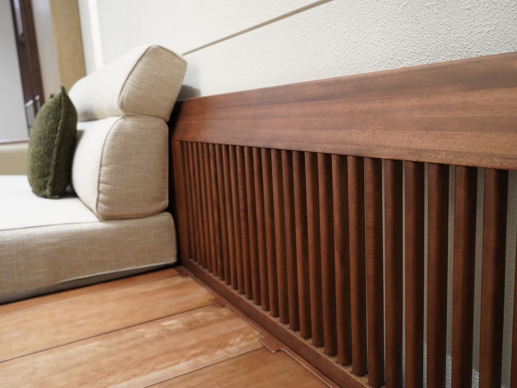 A minimalist sofa with a wooden slatted frame