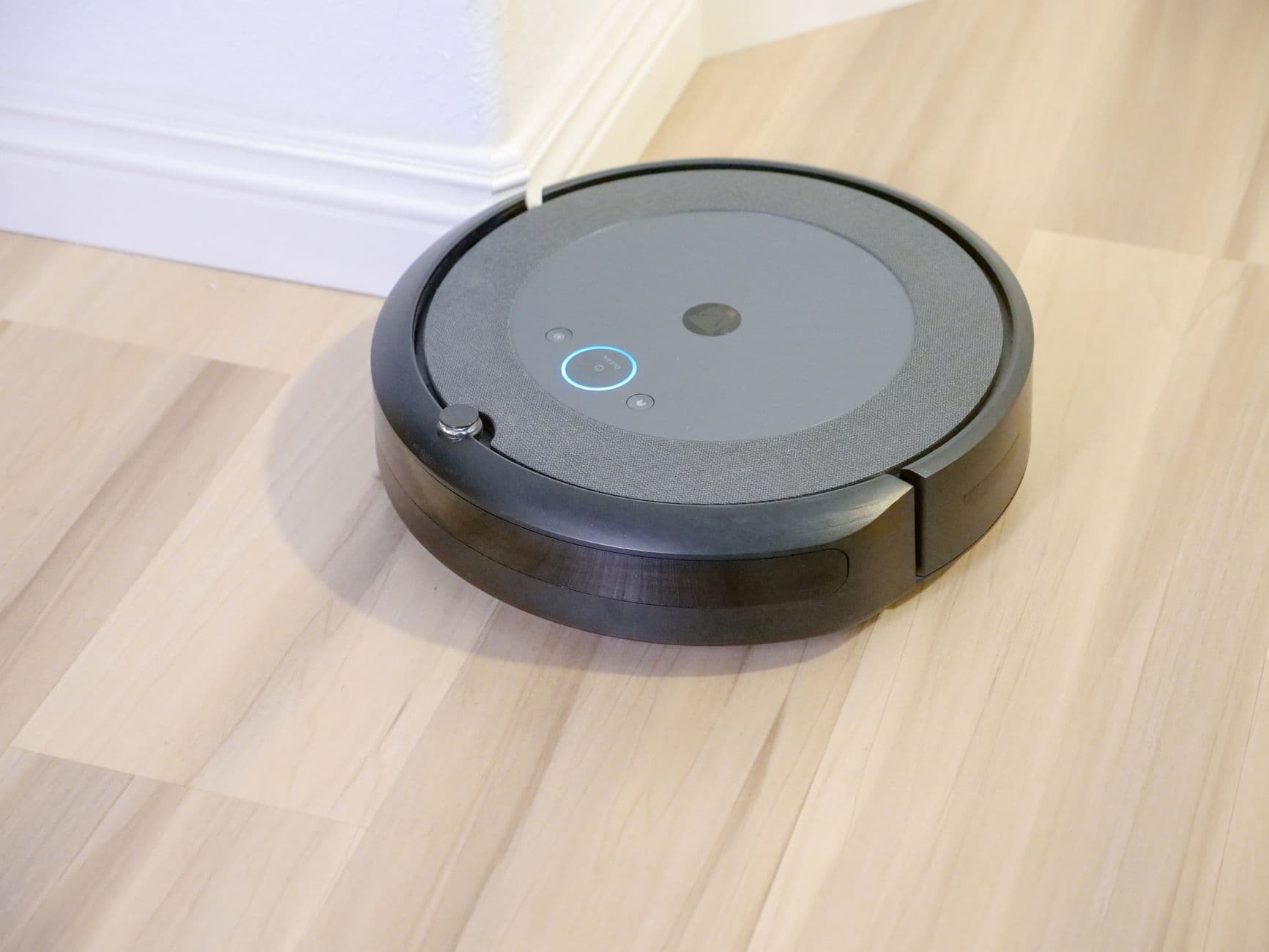 A robot vacuum cleaning a hardwood floor