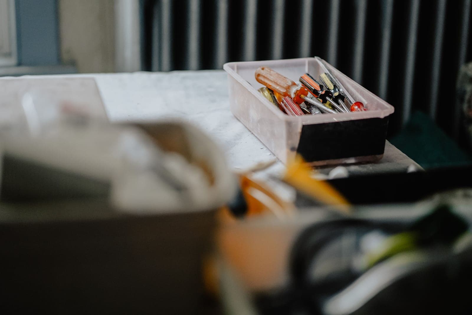 Tools and a screwdriver on a workbench