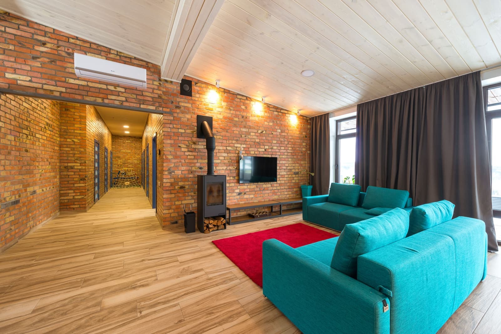 A warm living room with a sofa and a wooden floor