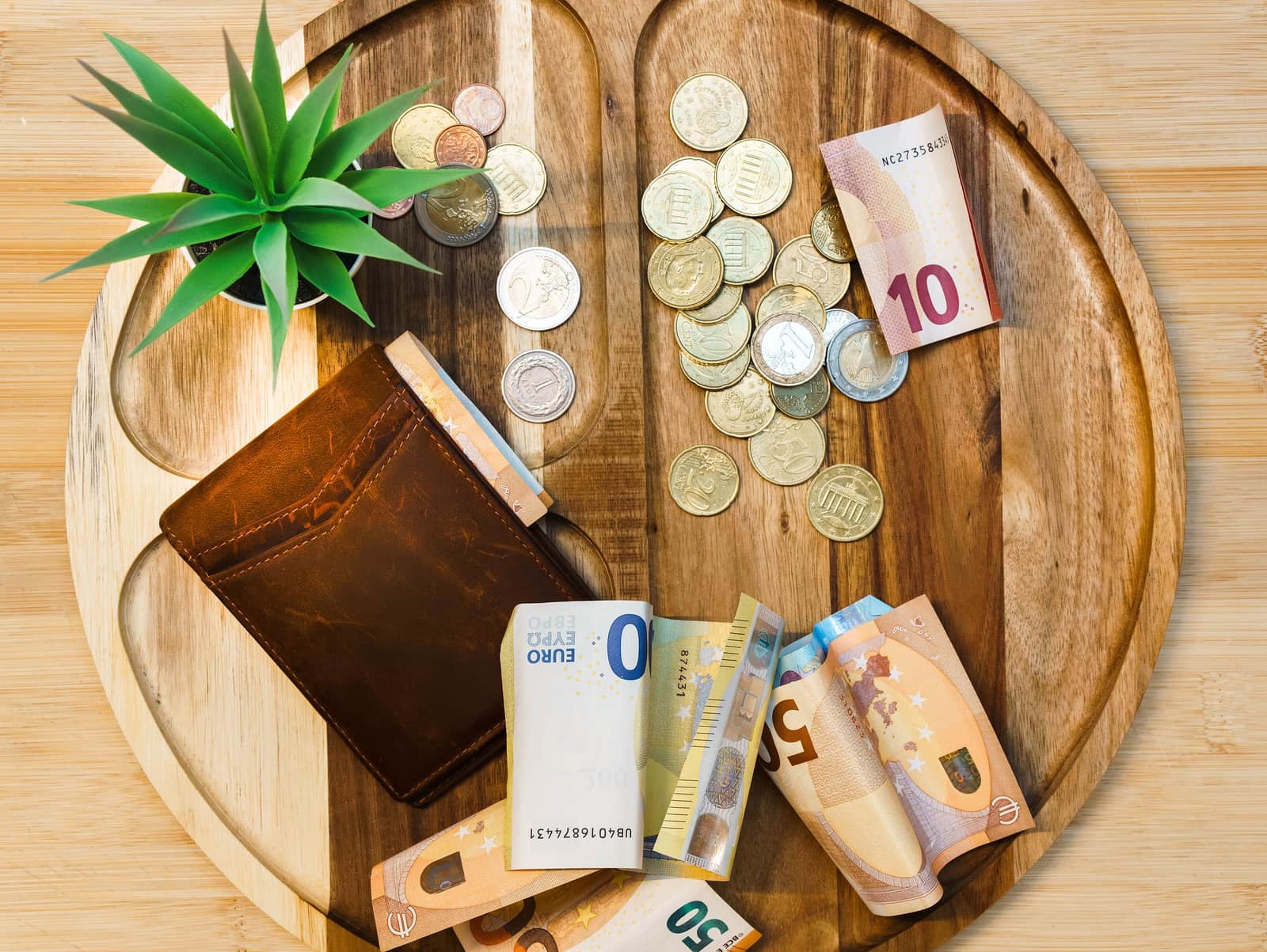 Cash and coins on a wooden table