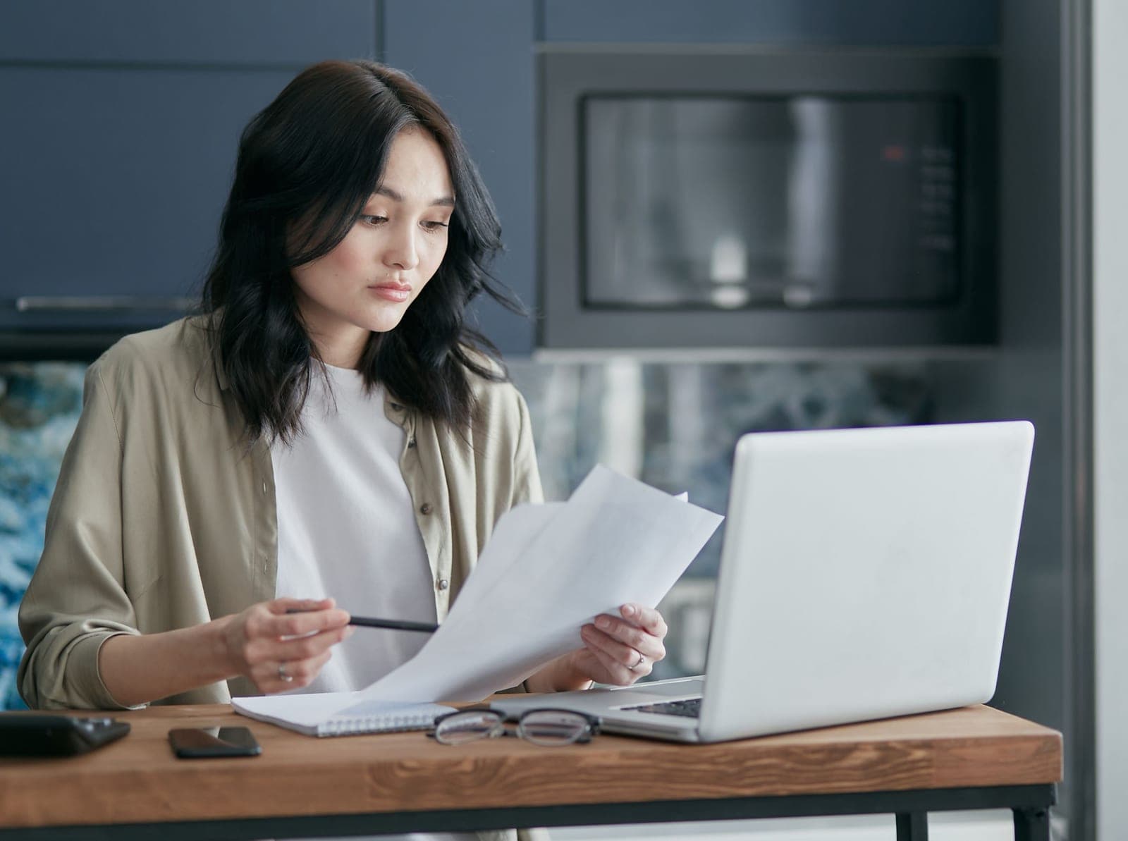 A person reading paperwork at a table